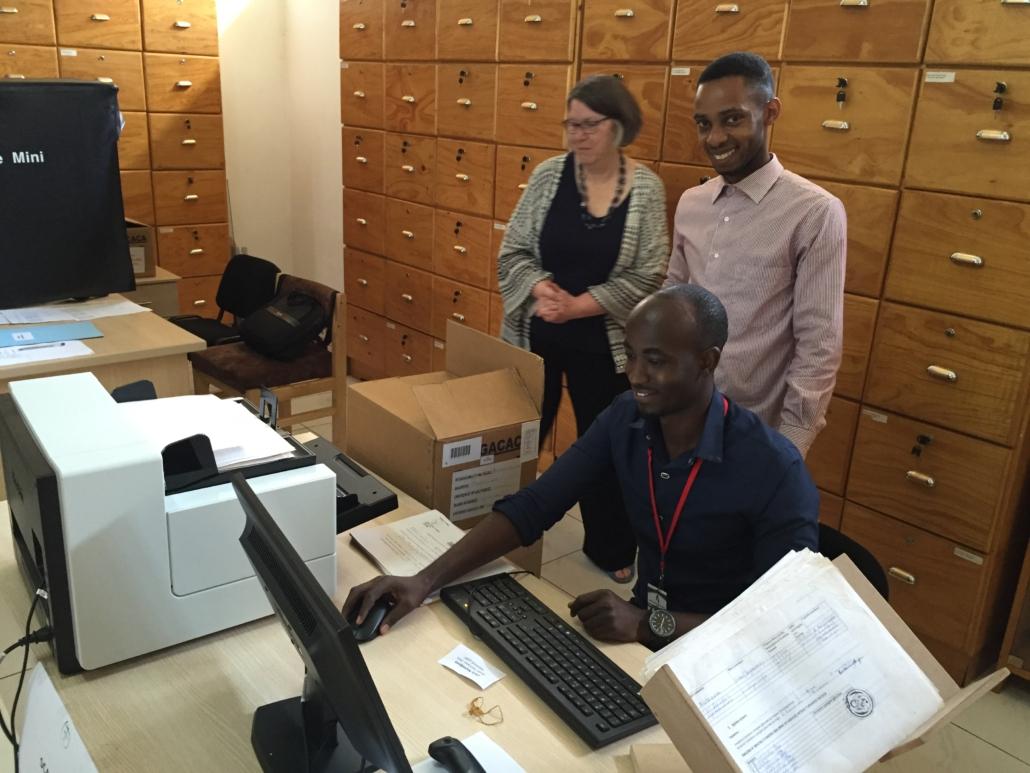 Project staff practice the workflow to prepare a box of court records for scanning.